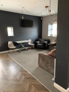 a living room with a couch and a table at My Perfect Place Rooms & Apartments -Some rooms with Hot Tub- Free Parking in Blackpool