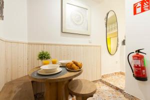 a table with a plate of food on it in a room at Almaden apartamento in Madrid