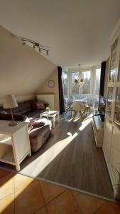 a living room with a couch and a table at Ferienwohnung Ostsee-Buhne Baabe in Baabe