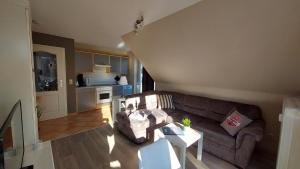 a living room with a couch and a table at Ferienwohnung Ostsee-Buhne Baabe in Baabe
