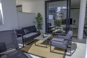 a living room with a couch and chairs and a table at Modern 2 bedroom luxury apartment in Higueron West in Fuengirola