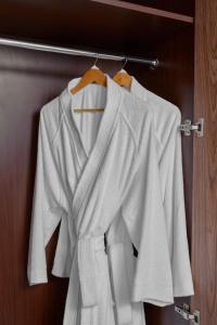 a group of white shirts hanging on a rack at voco Makkah an IHG Hotel in Makkah
