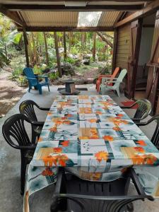 a table with a colorful table cloth on a patio at Chalet de Bérènice in Saint-Joseph
