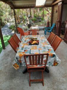 a table and chairs on a patio with a table and chairs at Chalet de Bérènice in Saint-Joseph +26 photos