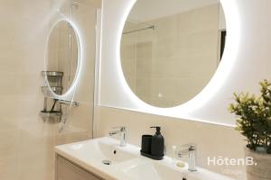 a bathroom with a sink and a mirror at "La Boétie" - 50 m2 de charme Limoges Centre in Limoges