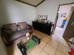 a living room with a couch and a glass table at Chalet de Bérènice in Saint-Joseph