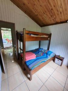 a bedroom with a bunk bed in a room at Chalet de Bérènice in Saint-Joseph