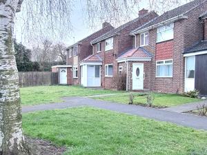 a brick house with a driveway in a yard at Shanti in Darlington