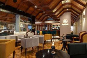 a restaurant with chairs and tables and a bar at Dorado Hotel Boutique - Tacna in Tacna