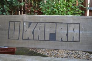 a wooden bench with the word truth written on it at Hotel u Kapra in Lázně Bělohrad