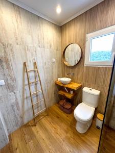 a bathroom with a toilet and a sink and a mirror at 4Cantos Alentejo in Mértola