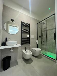 a bathroom with a sink and a toilet and a mirror at Campione 5 in Bari