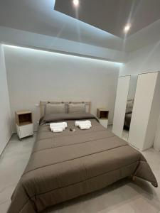 a bedroom with a large bed with two towels on it at Campione 5 in Bari