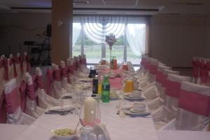 a long table with plates of food on it at U Hołosia in Osowiec