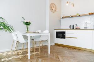 a kitchen with a white table and white chairs at HomeThirtyFour in Verona