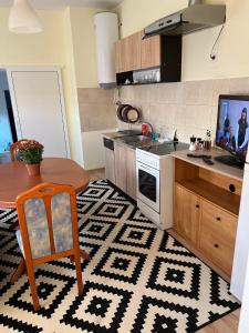 a kitchen with a table and a television and a kitchen with a table at Wohnung 18 in Lutherstadt Eisleben