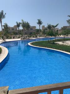 a large pool with blue water in a resort at Marlyn Paradys in Salalah