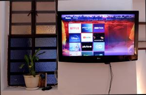 a flat screen tv hanging on a wall at RC Apartments in Bogotá