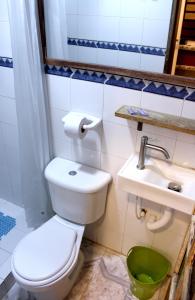 a bathroom with a toilet and a sink at RC Apartments in Bogotá