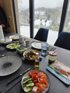 a table with plates of food on top of it at Odenwald-Lodge mit Infrarotsauna und E-Ladestation im Naturpark Odenwald "Haus Himmelblau" in Reichelsheim