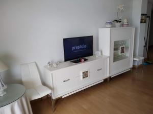 a white entertainment center with a flat screen tv on it at Mode's beachfront in Fuengirola