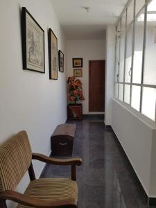 a hallway with two chairs and a stair case at Beautiful & fully renovated flat in historic city center in Quito