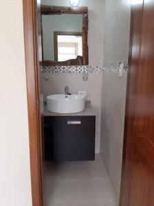 a bathroom with a sink and a mirror at Beautiful & fully renovated flat in historic city center in Quito