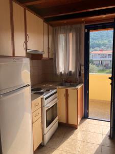 a kitchen with a sink and a stove top oven at STUDIOS ATHENA in Megalochori