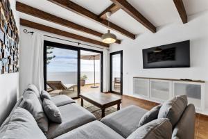 a living room with a couch and a view of the ocean at Villa 4 - VipVipVillas in Tías