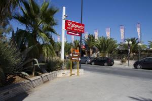 a sign for a restaurant on the side of a street at Oasi Beach Hotel in Vieste