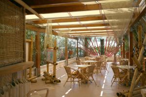 a restaurant with tables and chairs on a patio at Oasi Beach Hotel in Vieste