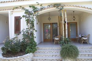 a home with a porch with stairs and plants at Oasi Beach Hotel in Vieste
