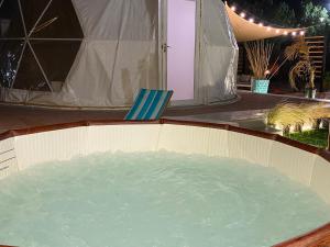 a tub filled with water next to a tent at Turquoise Resorts in Ar Ruways