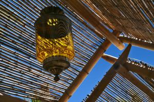 a chandelier hanging from a wooden roof at Oasi Beach Hotel in Vieste