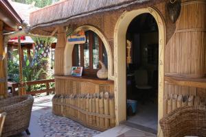 a wooden gingerbread house with an entry way at Oasi Beach Hotel in Vieste