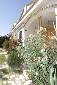 a house with a bunch of flowers in front of it at Oasi Beach Hotel in Vieste