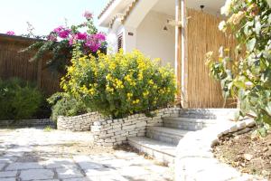 a garden with a retaining wall and stairs with flowers at Oasi Beach Hotel in Vieste