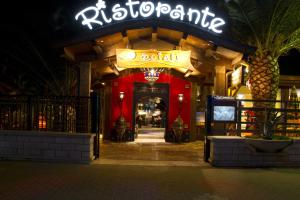 an entrance to a restaurant at night at Oasi Beach Hotel in Vieste