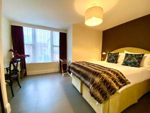 a hotel room with a large bed and a window at Stunning Apartment - 1 Minute walk to Poole Quay - Great Location - Free Parking - Fast WiFi - Smart TV - Newly decorated - sleeps up to 2! Close to Poole & Bournemouth & Sandbanks in Poole