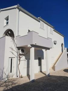 a white building with stairs on the side of it at Apartments Pralija in Sevid