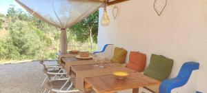 a patio with a wooden table and chairs at Herdade da Maceira in São Luis