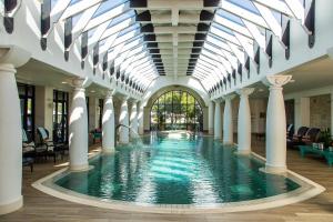 a swimming pool in a building with a glass ceiling at Santé Wellness Retreat & Spa in Paarl