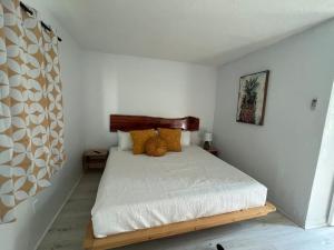 a bedroom with a bed with a wooden head board at Retro motel walk to beach, Wi-Fi in Daytona Beach