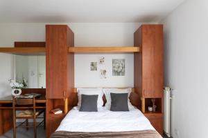 a bedroom with a bed with a wooden headboard at Appart Hotel Corte HR in Corte