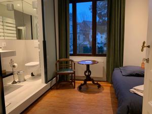a bedroom with a bed and a chair and a window at Albert Molière in Brussels +65 photos