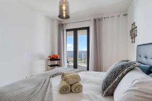 a bedroom with a bed with a view of the ocean at Apartment Nata by Holiday Rental Madeira in Caniço +30 photos