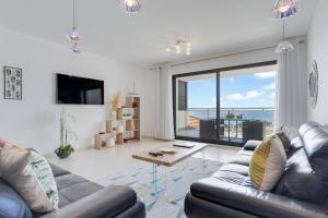 a living room with a couch and a table at Apartment Nata by Holiday Rental Madeira in Caniço