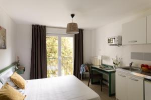 a kitchen with a table and a desk in a room at Appart Hotel Corte HR in Corte