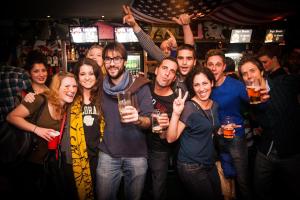a group of people posing for a picture in a bar at St Christopher's Inn Paris - Canal in Paris +20 photos