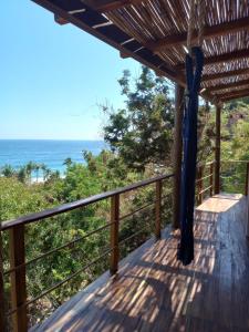 a deck with a view of the ocean at Posada La Sabila in Mazunte